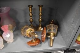 A pair of modern wall mounted carriage style lights and a pair of well cast candle sticks