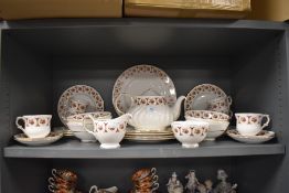 A part tea service by Royal Imperial having a gilt and burgundy glaze