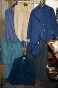 A collection of ladies retro skirt suits and jackets, different colours and styles.