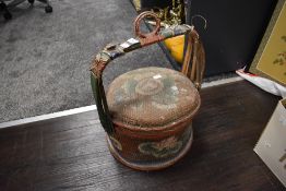 A Chinese styled woven fibre basket decorated with flowers and foliage