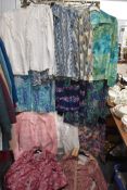 A collection of ladies retro blouses including bright patterned and florals.