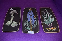 Three mid century wall plaques by Keramos Keramic depicting flowers