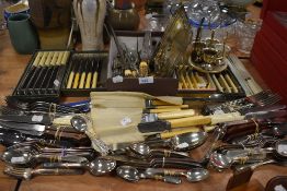 A large collection of flatware including bone handled knives and 1937 coronation spoons.