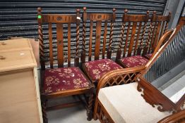 A set of four early 20th Century oak dining chairs having twist and railbacks