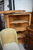 A stripped pine corner cupboard with glazed removable doors