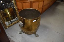 A late 19th or early 20th Century brass coal bucket having lion mask handles and claw feet, height