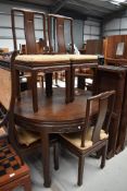 An Oriental hardwood extending dining table and six chairs