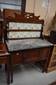 A Victorian mahogany marble top washstand having tile back