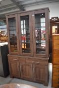 A modern laminated display case and dresser base unit having glazed and illuminated cabinet