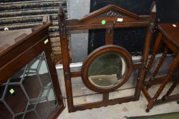 An early 20th Century oak framed hall mirror with coat hooks, wall mounted