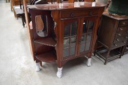 A late Victorian Dresser base having velvet and mirror back with glazed cupboard under