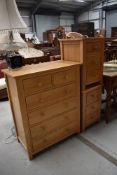 A modern golden oak bedroom chest of two over four drawers and a matching pair of bedside drawers
