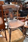 A traditional solid seat splat back kitchen chair