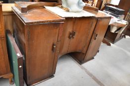 A 1930s oak sideboard having recessed centre cupboard