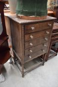 An early 20th Century oak music cabinet
