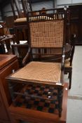A Victorian stained frame salon chair having later cane seat and back