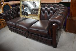 A vintage leather three seater chesterfield settee