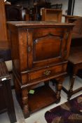 A reproduction oak (believed to be Titchmarsh and Goodwin) side cabinet (selling for St Johns