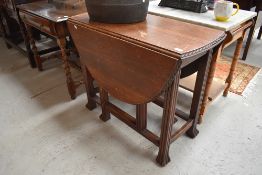 An early 20th Century oak gateleg table having gadrooned edge and fluted legs
