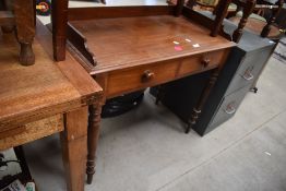 A Victorian mahogany wash stand having ledge back, two frieze drawers and turned legs