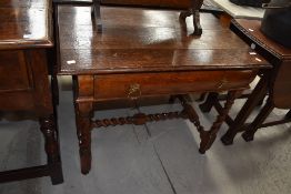 A period vernacular oak side table having single bombe style drawer, barley twist frame including