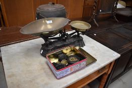 A vintage kitchen scale and selection of weights, including Victorian brass (selling for St Johns