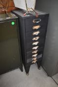 A vintage filing drawer set with additional shepherds casters