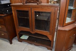 A 19th Century mahogany bookcase , glazed section over two open shelves , possibly on later base,