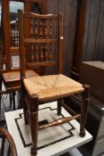 A traditional rush seated spindle back chair