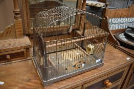 A vintage bird cage, labelled Genykage