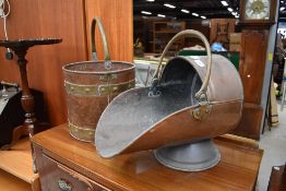 A traditional copper and brass coal bucket and similar helmet (selling for St Johns Hospice,
