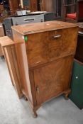 A mid 20th Century walnut cocktail cabinet of compact form, width 54cm