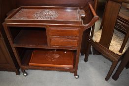 An Oriental hardwood tea trolley