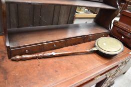 A traditional brass warming pan