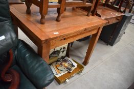 An early 20th Century golden oak fold over dining table