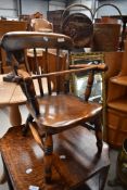 A 19th Century stained frame child's low windsor style chair, having safety rail (selling for St