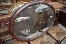 An over mantle mirror having oval scumble finished frame
