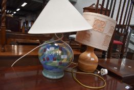 A ceramic table lamp and a turned wood table lamp