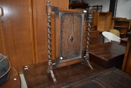 An early 20th Century oak firescreen in the Jacobean style (selling for St Johns Hospice,