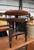 A 19th Century mahogany swivel piano stool, later upholstery