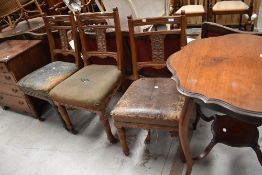 A set of three Victorian oak framed dining chairs having pokerwork and carving to back pabel,