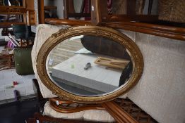A vintage gilt oval wall mirror
