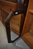 An early 20th Century oak framed canted wall mirror (selling for St Johns Hospice, Lancaster)