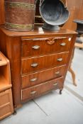 A mid 20th Century walnut four drawer bedroom chest