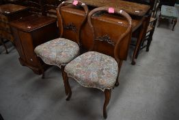 A pair of Victorian balloon back dining or salon chairs