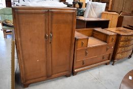 An early to mid 20th Century golden oak dressing table and tall boy