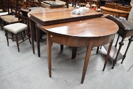 A Georgian mahogany 'D' end dining table having central frame, two additional leaves and demi lune