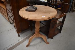 A natural pine pedestal table having circular top, turned pedestal and triple splay legs, diameter