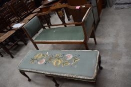 An Edwardian mahogany salon settee having inlay decoration and later green dralon upholstery, some