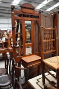 A Victorian oak framed hall stand, having mirror and tile back, with spindle and fretwork